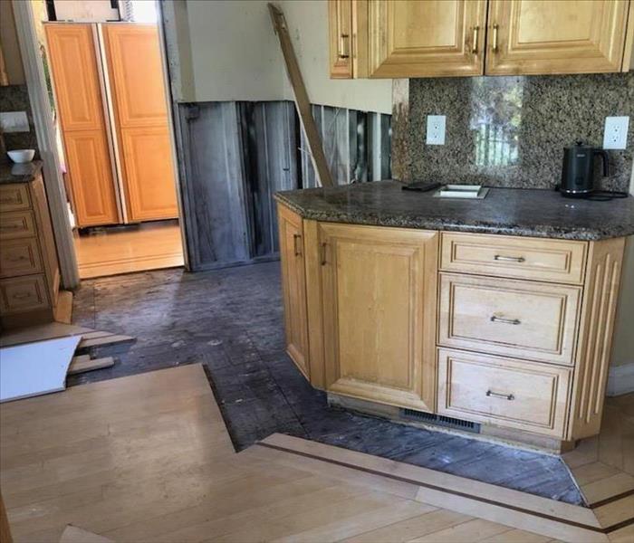 Kitchen cabinets and laminate floor removed to mitigate water damage