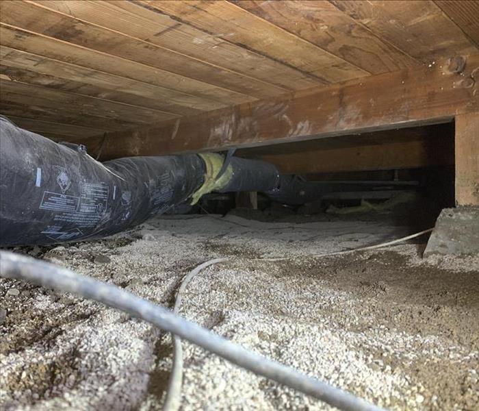 Crawlspace showing water gone and absorbent spread in affected area