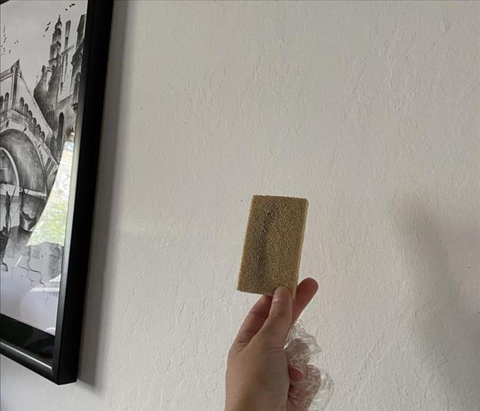 Sponge used to test white wall for soot damage