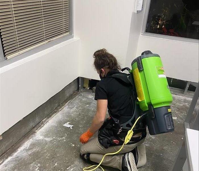 Technician doing final cleaning with a vacuum after demolition